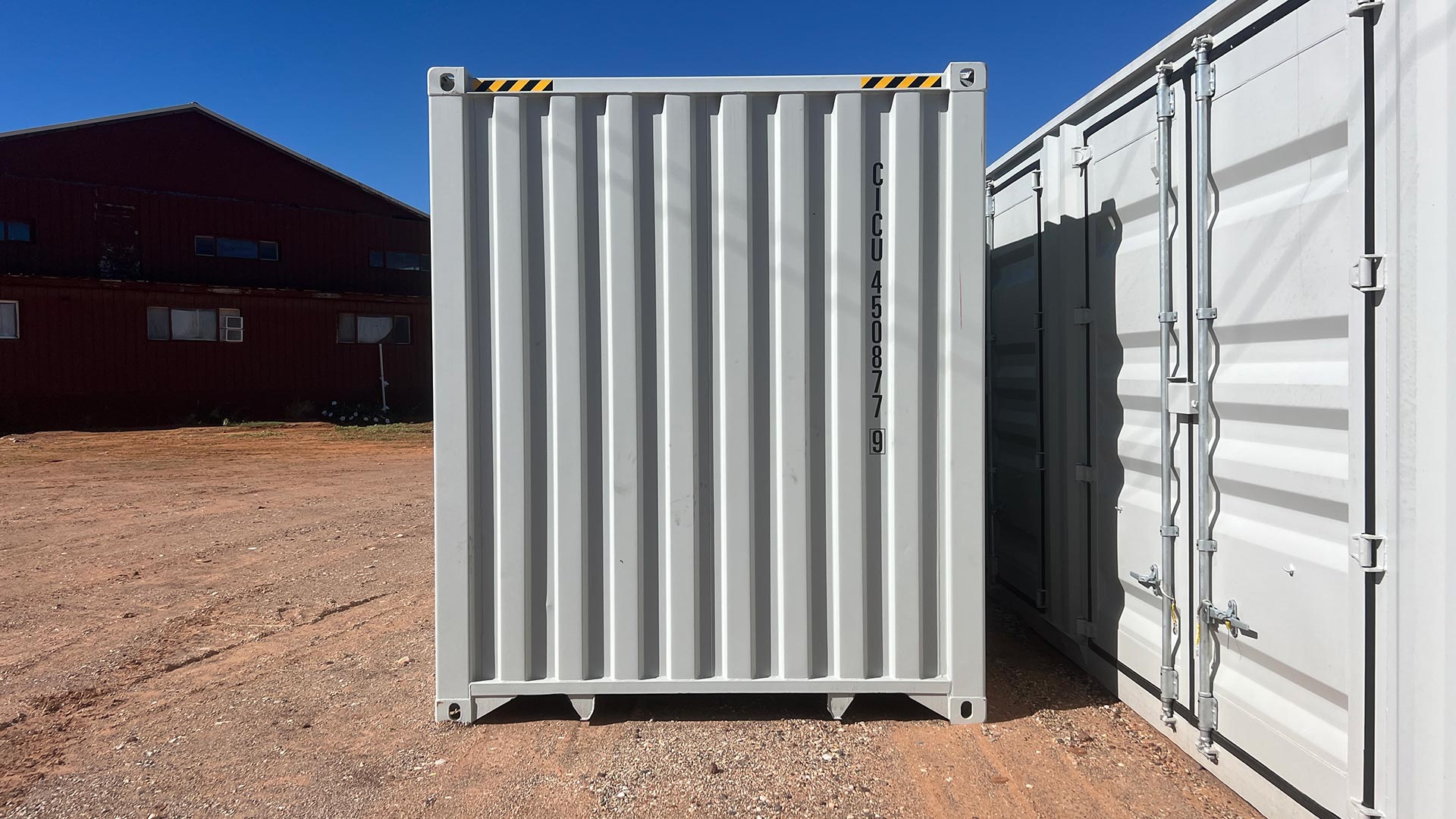 Container end wall and adjacent closed side doors in the Container Bros yard